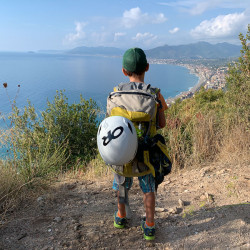 Kind mit Kletterrucksack auf einem Weg über dem Meer, Jahresrückblick 2021