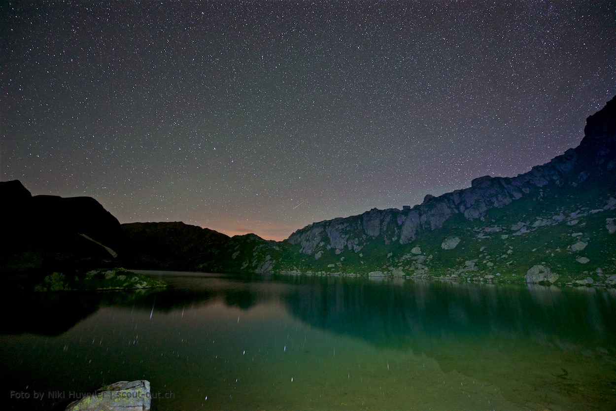 Nacht der Perseiden: Ruhiger Bergsee unter dem Sternenhimmel